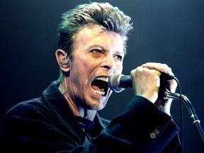 British pop star David Bowie screams into the microphone as he performs on stage during his concert in Vienna, February 4, 1996.