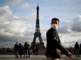 A man, wearing protective face mask, walks at Trocadero square near the Eiffel Tower in Paris amid the coronavirus outbreak in France, January 22, 2021.