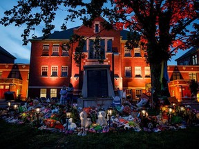 A makeshift memorial is seen outside the former Kamloops Indian Residential School, where the remains of 215 children have been discovered in unmarked and undocumented graves.