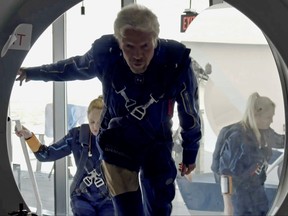 Richard Branson and Virgin Galactic crew members enter the company's passenger rocket plane, the VSS Unity, in a still image from undated handout video taken at Spaceport America near Truth or Consequences, N.M.