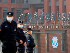 Security personnel keep watch outside the Wuhan Institute of Virology during the visit by the World Health Organization (WHO) team tasked with investigating the origins of the coronavirus disease (COVID-19), in Wuhan, Hubei province, China February 3, 2021.