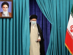 (FILES) In this file photo Iran's Supreme Leader Ayatollah Ali Khamenei wears a face mask due to the Covid-19 pandemic, as he arrives to cast his ballot on June 18, 2021, on the day of the Islamic republic's presidential election.