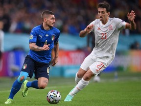 Italy midfielder Marco Verratti (left) moves the ball against Spain's Mikel Oiarzabal during their UEFA EURO 2020 semifinal match at Wembley Stadium in London, U.K., on July 6, 2021.