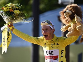 Tadej Pogacar of Slovenia celebrates his overall leader yellow jersey on the podium at the end of the 21th and final stage of the 108th Tour de France cycling race in Paris on July 18, 2021.