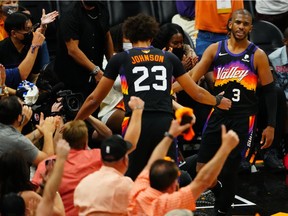 Phoenix Suns guard Chris Paul (3) reacts with forward Cameron Johnson (23) after drawing a foul against the Milwaukee Bucks during the second half in game one of the 2021NBA Finals at Phoenix Suns Arena.