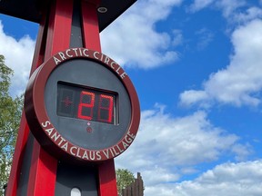 A thermometer reads 27 degrees Celsius at the main square of the Santa Claus Village in the Arctic Circle near Rovaniemi in Lapland, Finland, on July 9, 2021.