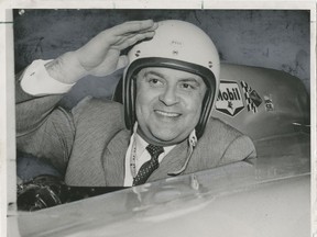 Former Social Credit highways minister Phil Gaglardi loved to play up his penchant for getting speeding tickets by posing in race cars, wearing a crash helmet. Here he is on March 16, 1960. The print has been touched up for the paper by a staff artist. Ray Allan/Vancouver Sun