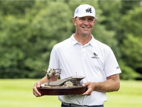 Lucas Glover holds his 2021 John Deere Classic winners trophy after finishing the final round of the John Deere Classic golf tournament. Mandatory Credit: Marc Lebryk-USA TODAY Sports