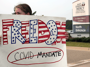 A protest against mandatory COVID-19 vaccinations for healthcare workers in front of a hospital in Livonia, Michigan, on July 24, 2021.