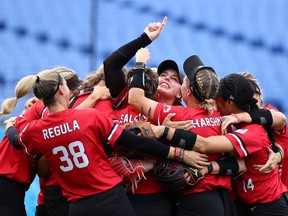Team Canada celebrates after winning the bronze medal game in women's softball on Wednesday at the Tokyo Olympics.