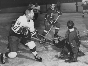 Vancouver Canucks legend Phil Maloney (left) in action against the Seattle Totems at the Forum in the 1960s. Maloney was the top Canucks player when they were in the Western Hockey League.