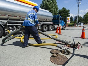 Fuel is replenished at a gas station in Coquitlam on July 3. The Lower Mainland is currently seeing record-high gasoline prices.