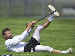 B.C. Lions quarterback Mike Reilly stretches at the team's training facility in Surrey. The team is off to Kamloops for their training camp, and the club will be taking extra precautions to limit injuries as they return from a 20-month layoff.