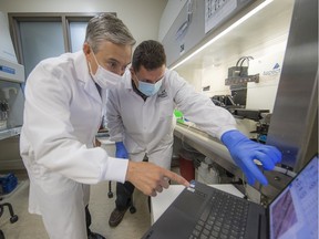 Federal Minister of Innovation François-Philippe Champagne with a lab tech during a visit to Aspect Biosystems on Wednesday,