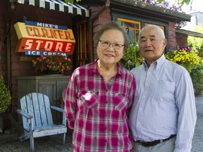 Dick Chan and his wife Donna ran Mike's Grocery at East 24th and Knight Street from 1970 to 1988. After the store closed, the neon sign that stood outside their store ended up at an antique store, until John Davis bought it and displayed it at his house on West 10th Ave. The Chans and the sign were reunited Wednesday at Davis' house.