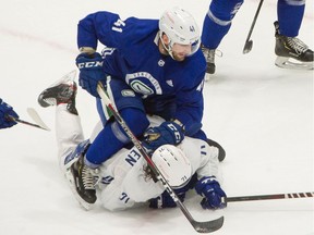 VANCOUVER, BC - January 6, 2021  - Vancouver Canucks  Jonah Gadjovich rides on Zack MacEwen  during scrimmage game at Rogers Arena in Vancouver, BC, January 6, 2021. Covid-19 pandemic restrictions were in force to photographers offering limited shooting positions.

Photo by Arlen Redekop / Vancouver Sun / The Province (PNG) (story by reporter) [PNG Merlin Archive]