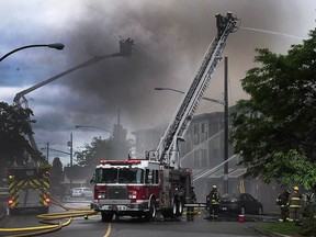 Firefighters battle a massive fire in a condominium construction site near Johnston Road and Buena Vista Avenue in the Five Corners area of White Rock on May 15, 2016.
