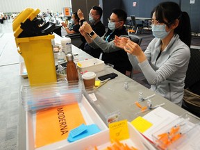 Clinic staff prepare vaccines during an immunization event in Vancouver last month.