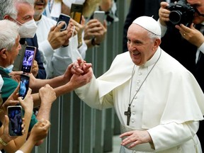 Pope Francis greets people as he attends an event to mark 50 years since the foundation of Catholic charity Caritas Italiana, at the Paul VI Audience Hall, at the Vatican, June 26, 2021.