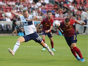 Vancouver Whitecaps midfielder Andy Rose (15) defends Real Salt Lake forward Bobby Wood (7) as he heads a ball towards the goal in the first half at Rio Tinto Stadium.