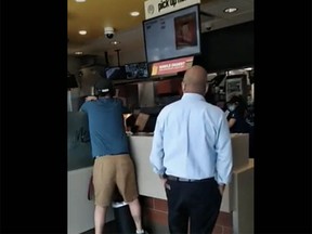Screen capture from Reddit video showing a man lashing out at employees at a Richmond McDonald's.
