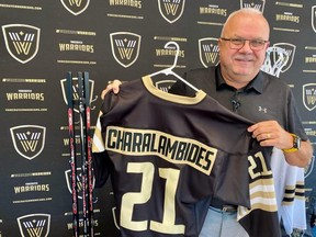 Vancouver Warriors general manager Dan Richardson with a jersey he had made for first-round draft pick Adam Charalambides.