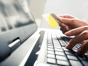 Woman using credit card online. Stock Image.