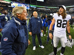 Head coach Pete Carroll of the Seattle Seahawks and Luke Willson #82 of the Oakland Raiders catch up after the preseason game at CenturyLink Field on August 29, 2019 in Seattle, Washington.
