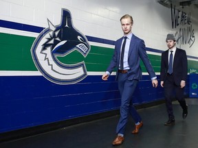 ‘We know how important to the Canucks they are,’ agent Pat Brisson says of budding Vancouver superstars Elias Pettersson (left) and Quinn Hughes (right).
