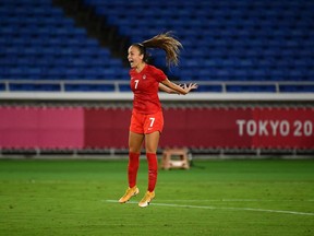 Canada's midfielder Julia Grosso celebrates after score the winning penalty during the penalty shoot-out of the Tokyo 2020 Olympic Games women's final football match between Sweden and Canada.