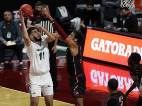 Fardaws Aimaq of the Utah Valley Wolverines, taking a shot over a New Mexico State defender during an NCAA game in March, topped the NCAA in rebounding (15 per game) last season.