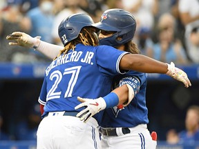 Toronto Blue Jays shortstop Bo Bichette (11) is greeted at home plate by Vladimir Guererro Jr. after hitting a two run home run against the Cleveland Indians at Rogers Centre.