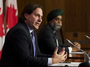 Immigration Minister Marco Mendicino, left, is joined by Harjit Sajjan, Minister of National Defence, at a press conference in Ottawa on Friday, July 23, 2021.