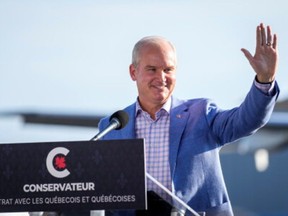 Canada's opposition Conservative party leader Erin O'Toole waves during a speech at Chrono Aviation during his election campaign tour in Quebec City, Quebec, Canada August 18, 2021.