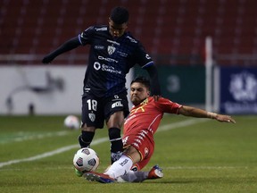 Ecuador's Independiente del Valle Pedro Vite, left, gets by Chile's Union Espanola Marcelo Jorquera vie for the ball during their Copa Libertadores football tournament second round match at the Rodrigo Paz Delgado Stadium in Quito in March.