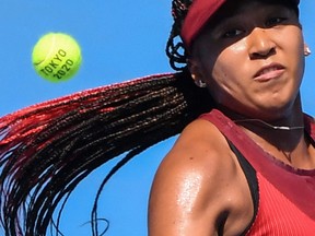 In this file photo Japan's Naomi Osaka eyes the ball as she returns a shot to China's Zheng Saisai during their Tokyo 2020 Olympic Games women's singles first round tennis match at the Ariake Tennis Park in Tokyo on July 25, 2021.