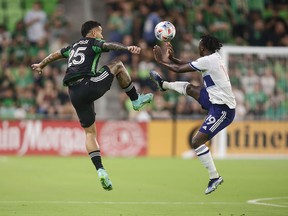 Austin FC forward Sebastian Driussi and Vancouver Whitecaps midfielder Janio Bikel battle for the ball in the first half at Q2 Stadium.