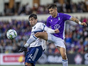 Pacific FC's Kadin Chung kicks the ball in front of Vancouver Whitecaps' Brian White in Canadian Championship first-round action at Starlight Stadium in Victoria, B.C., on Aug.  26, 2021.