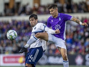 Langford-based Pacific FC’s Kadin Chung (right) vies for the ball with Vancouver Whitecaps striker Brian White during a Canadian Championship game in Langford, near Victoria, this summer. The owners of the Pacific FC are behind the new Canadian Premier League franchise in the Lower Mainland, set to start play in 2023.