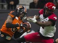 B.C. Lions cornerback T.J. Lee intercepts a pass intended for Calgary Stampeders receiver Hergy Mayala during a 2019 game. The Lions have 11 picks on the year, second-most in the CFL.