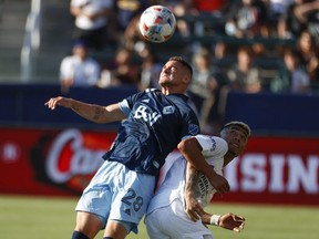 Vancouver Whitecaps defender Jake Nerwinski (left) and the L.A. Galaxy’s Julian Araujo vie for the ball during the first half of Sunday’s Major League Soccer game in Carson, Calif.