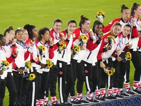 Canada celebrates with their gold medals after defeating Sweden in the penalty shoot-out in the women's soccer final during the summer Tokyo Olympics.