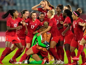 Canada's players celebrate winning 4-3 in a penalty shootout against Brazil during a women's quarterfinal soccer match.