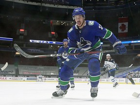 Travis Hamonic of the Vancouver Canucks skates up ice during their NHL game against the Winnipeg Jets at Rogers Arena on March 24, 2021 in Vancouver.