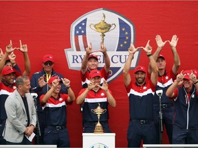 Members of the United States Ryder Cup team make W's as they are presented with the Ryder Cup at Whistling Straits on September 26, 2021 in Kohler, Wisconsin.