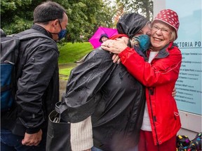 Marlene Lavallee hugs her son's wife, Lee Ann Mangin, as son Paul Lavallee, left, looks on after the Clipper arrived in the Inner Harbour on Friday.