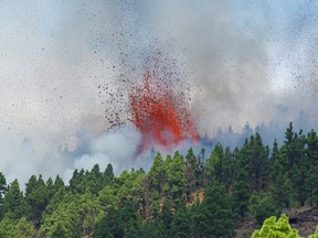 Lava and smoke are seen following the eruption of a volcano in the Cumbre Vieja national park at El Paso, on the Canary Island of La Palma, September 19, 2021.