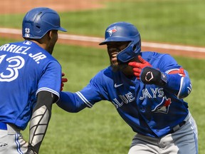 Blue Jays' Teoscar Hernandez (right) and teammate Lourdes Gurriel Jr. after hitting a grand slam home run during the third inning at Oriole Park at Camden Yards on Sunday, Sept. 12, 2021.
