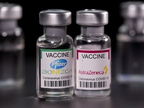 FILE PHOTO: Picture illustration of vials with Pfizer-BioNTech and AstraZeneca coronavirus disease (COVID-19) vaccine labels