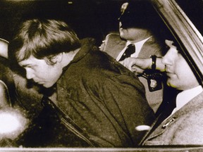 This 30 March 1981 file photo shows John Hinckley Jr. (L) escorted by police in Washington, DC, following his arrest after shooting and seriously wounding then president Ronald Reagan.
